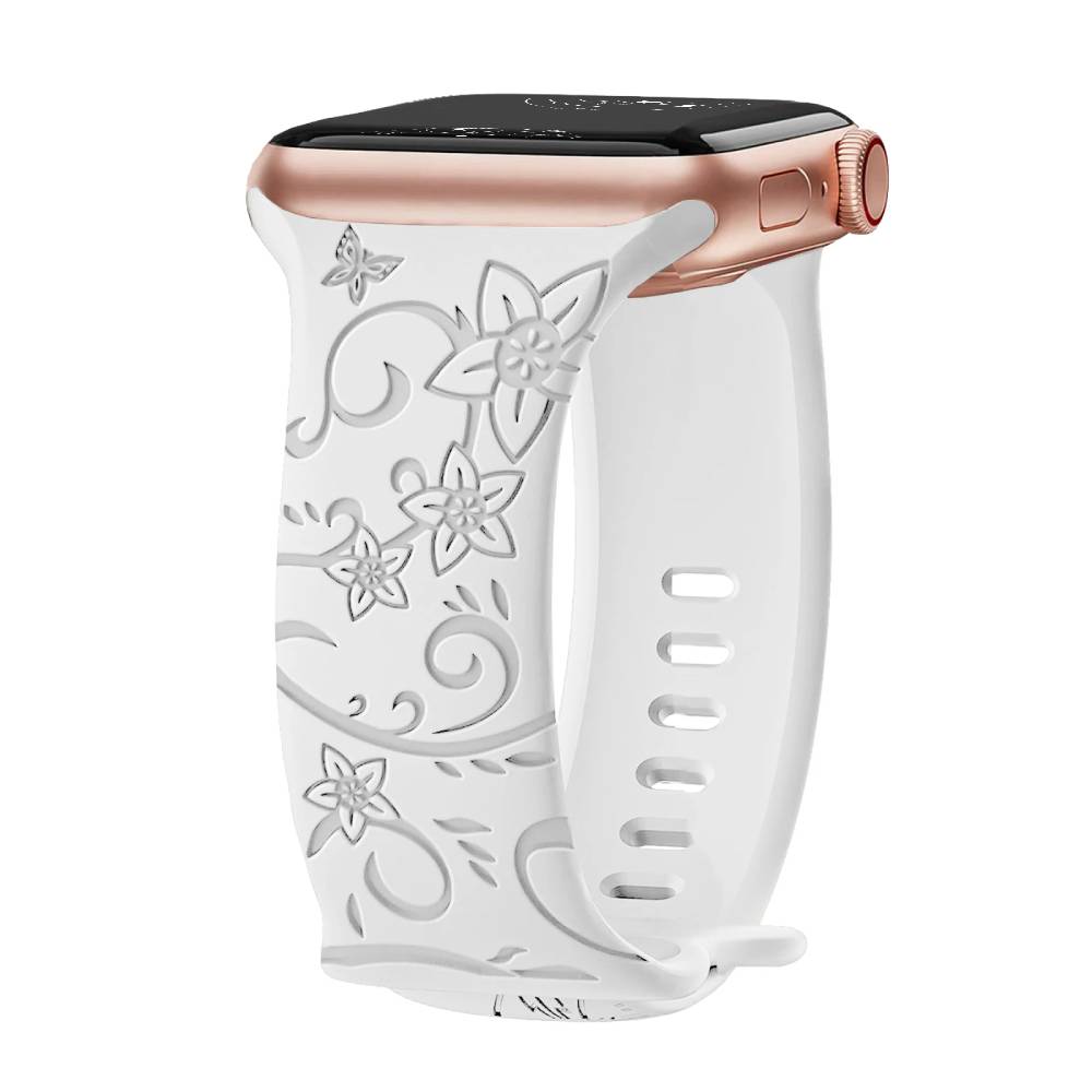 White silicone Apple Watch band featuring an engraved balloon flower design.